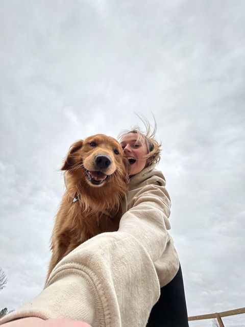 A happy Flat4Pet caregiver with a dog