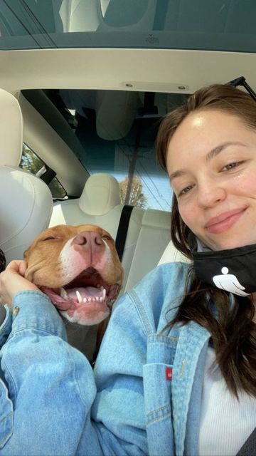 A smiling caregiver with a happy dog